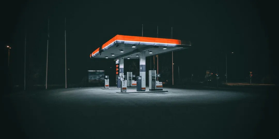 A petrol station lit up at night with nobody around