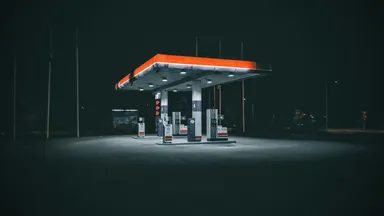 A petrol station lit up at night with nobody around