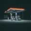 A petrol station lit up at night with nobody around