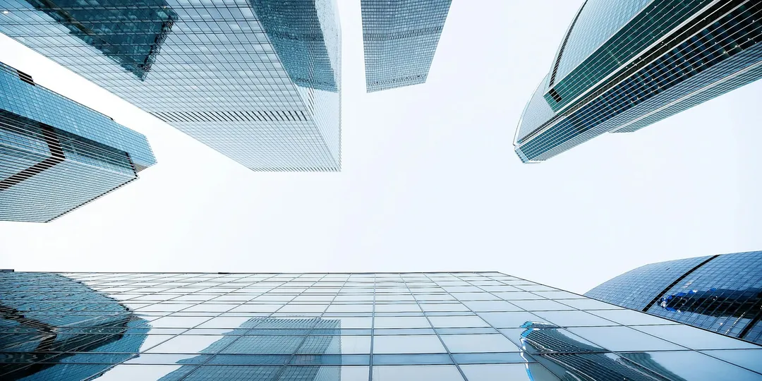 Glass office towers photographed from street level looking up