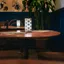 An empty round table with chairs pushed in, in a quiet restaurant