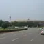 A broad road through New Delhi's government district with the Indian Parliament in the distance