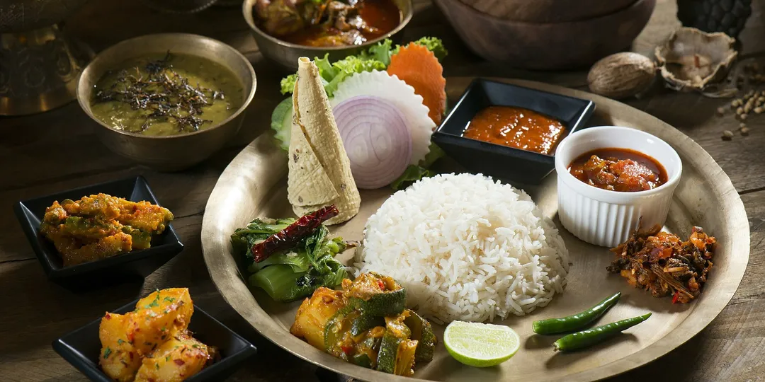 A South Asian thali of rice, dal, vegetables, pickle and flatbread
