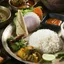 A South Asian thali of rice, dal, vegetables, pickle and flatbread
