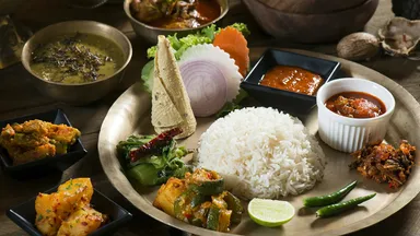 A South Asian thali of rice, dal, vegetables, pickle and flatbread