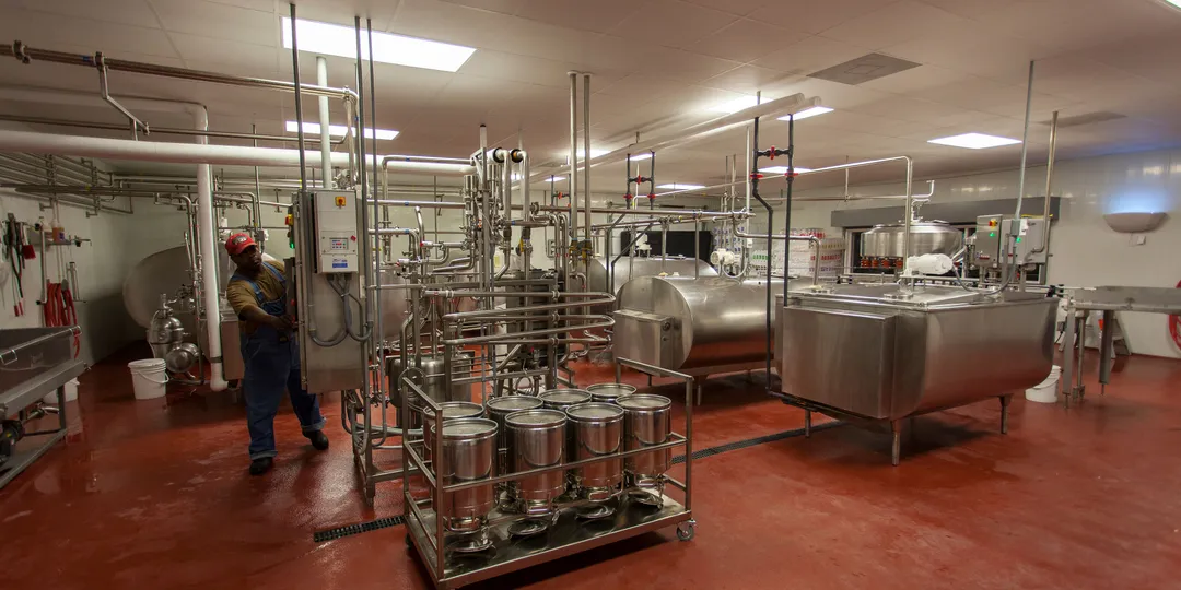 Stainless-steel tanks and pipes inside a modern dairy processing plant