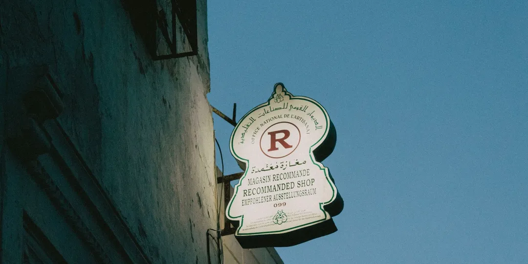 A shop sign carrying the same message in Arabic, French, English and German