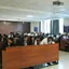 Rows of students seated at desks in a large lecture hall