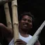 A construction worker on a bamboo-scaffolded building site in India