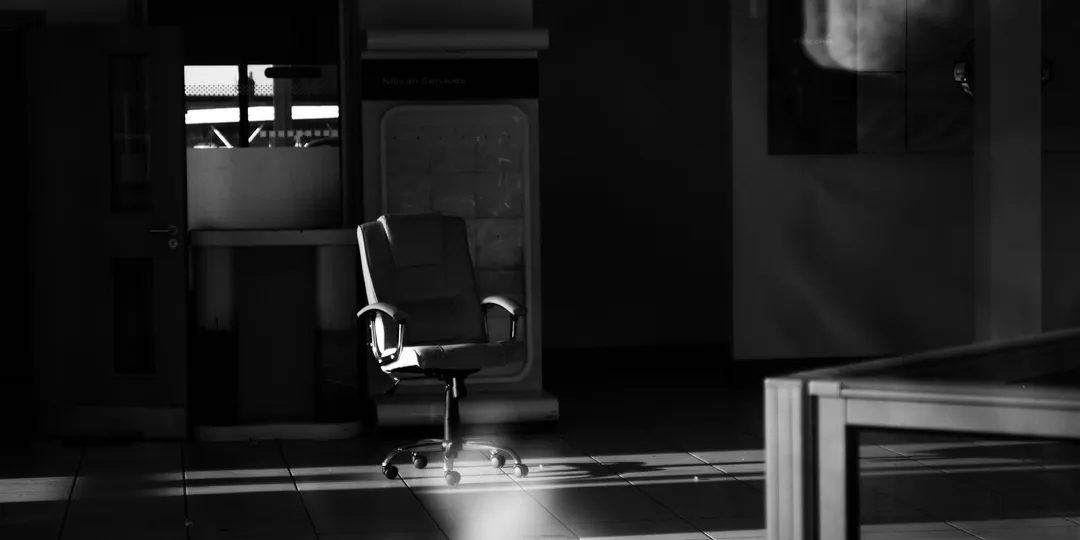 A grayscale photograph of an empty, abandoned interior