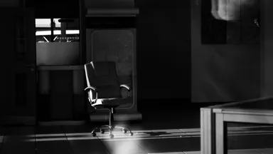 A grayscale photograph of an empty, abandoned interior