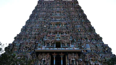 A gopuram at the Meenakshi temple in Madurai, densely covered with painted sculpted figures