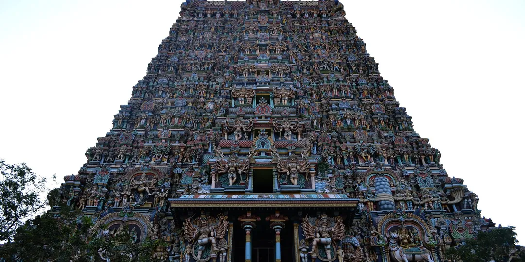 A gopuram at the Meenakshi temple in Madurai, densely covered with painted sculpted figures