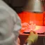 A laboratory scientist handling samples under red light