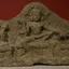 A carved stone panel of the Tamil guardian deity Aiyanar flanked by his two consorts and attendant figures