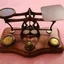 An old balance scale and a row of brass weights